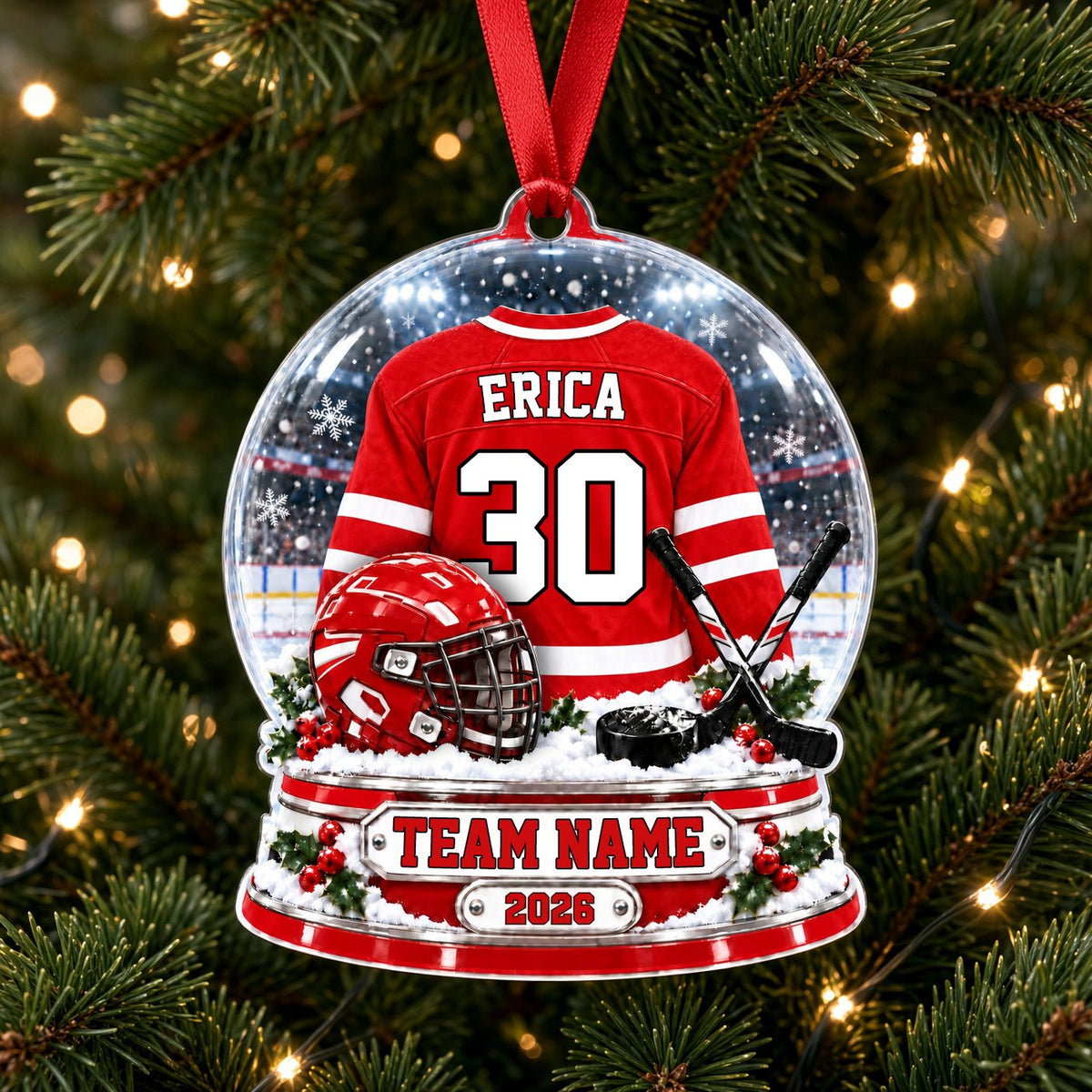 Acrylic snow globe ornament with red hockey jersey, helmet, crossed sticks, puck, holly and a silver name plaque.