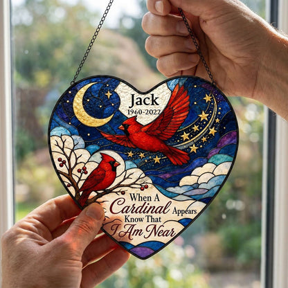 Heart stained-glass suncatcher with two red cardinals, a crescent moon, stars, and a branch with red berries.