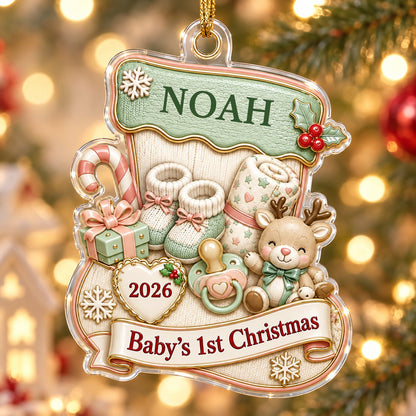 Stocking-shaped acrylic ornament with baby booties, reindeer toy and Baby's 1st Christmas on a cream banner.