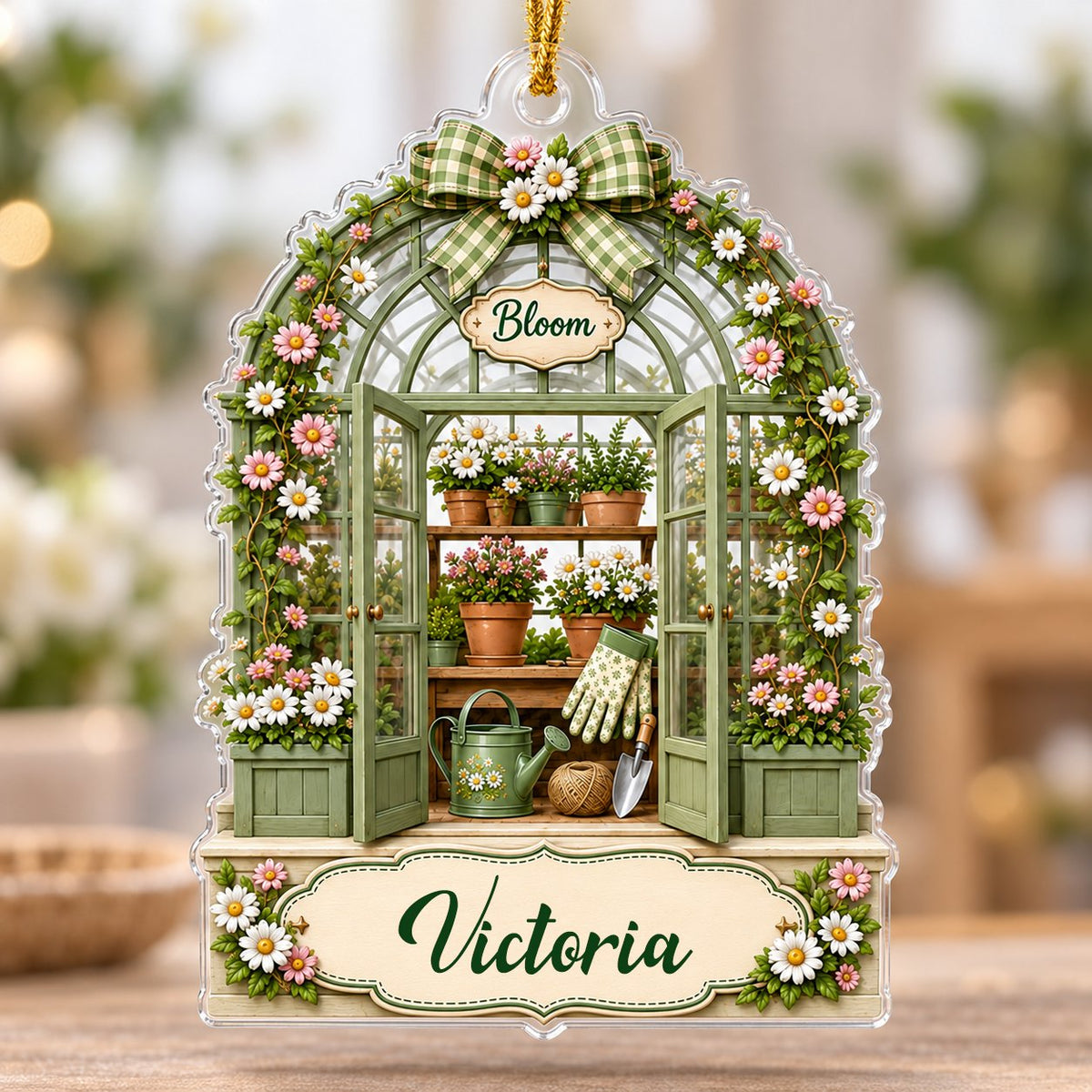 Arched acrylic ornament of a green greenhouse with daisy bow, flowers, tools, and 'Bloom' with a personalized name.
