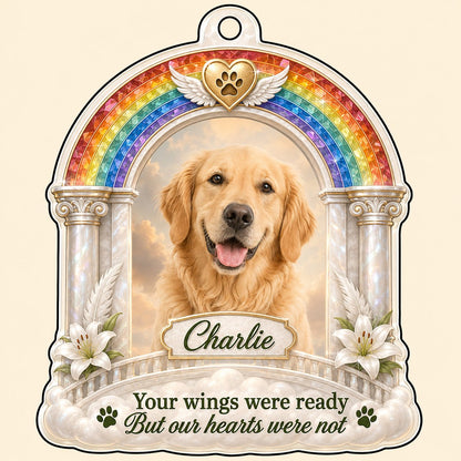 A rainbow arch pet memorial acrylic ornament with a winged golden heart, paw print, lilies, pillars, clouds and a photo 