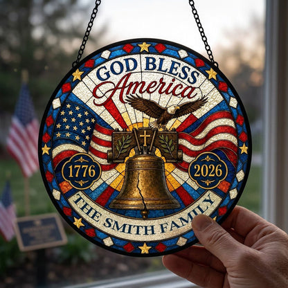 Round stained-glass style suncatcher with Liberty Bell, eagle, flags, 'GOD BLESS America' 1776–2026 and a family name