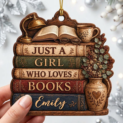 Bookshelf-shaped wood ornament with lamp, open book, teacup, vase, and Just a Girl Who Loves Books text.