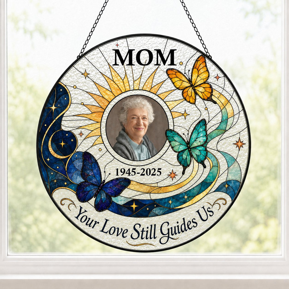 Round stained glass-style suncatcher with a photo frame, three butterflies, a crescent moon, sunburst rays and a banner 