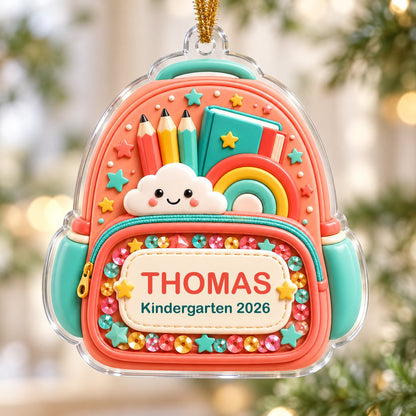 Coral backpack acrylic ornament with pencils, rainbow, smiling cloud, and 'THOMAS' Kindergarten 2026.