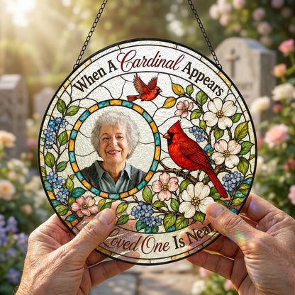 Round faux stained-glass suncatcher with two red cardinals, dogwood flowers, and a left-side circular photo frame.