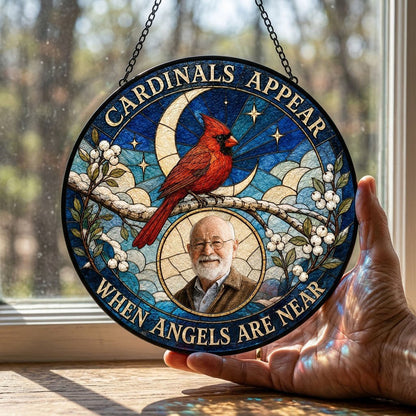Round stained-glass style suncatcher with a red cardinal, starry blue sky, crescent moon, and a circular frame with a pe