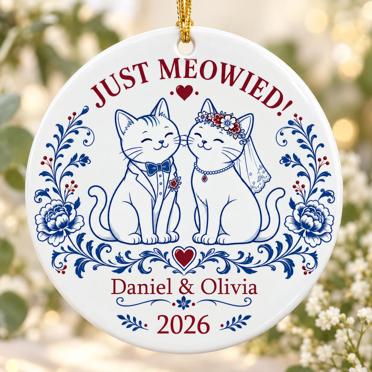 Round ceramic ornament with two wedding cats, 'JUST MEOWIED!', names and year with blue and red folk floral accents