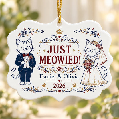 Medallion ceramic ornament with cat bride and groom, gold crown, floral scrolls, red hearts and paw prints on white.