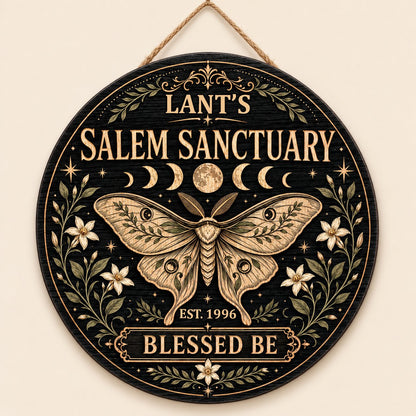 Round wooden sign with a central moth, moon phases, floral vines, stars, and 'Salem Sanctuary' 'Blessed Be' text.