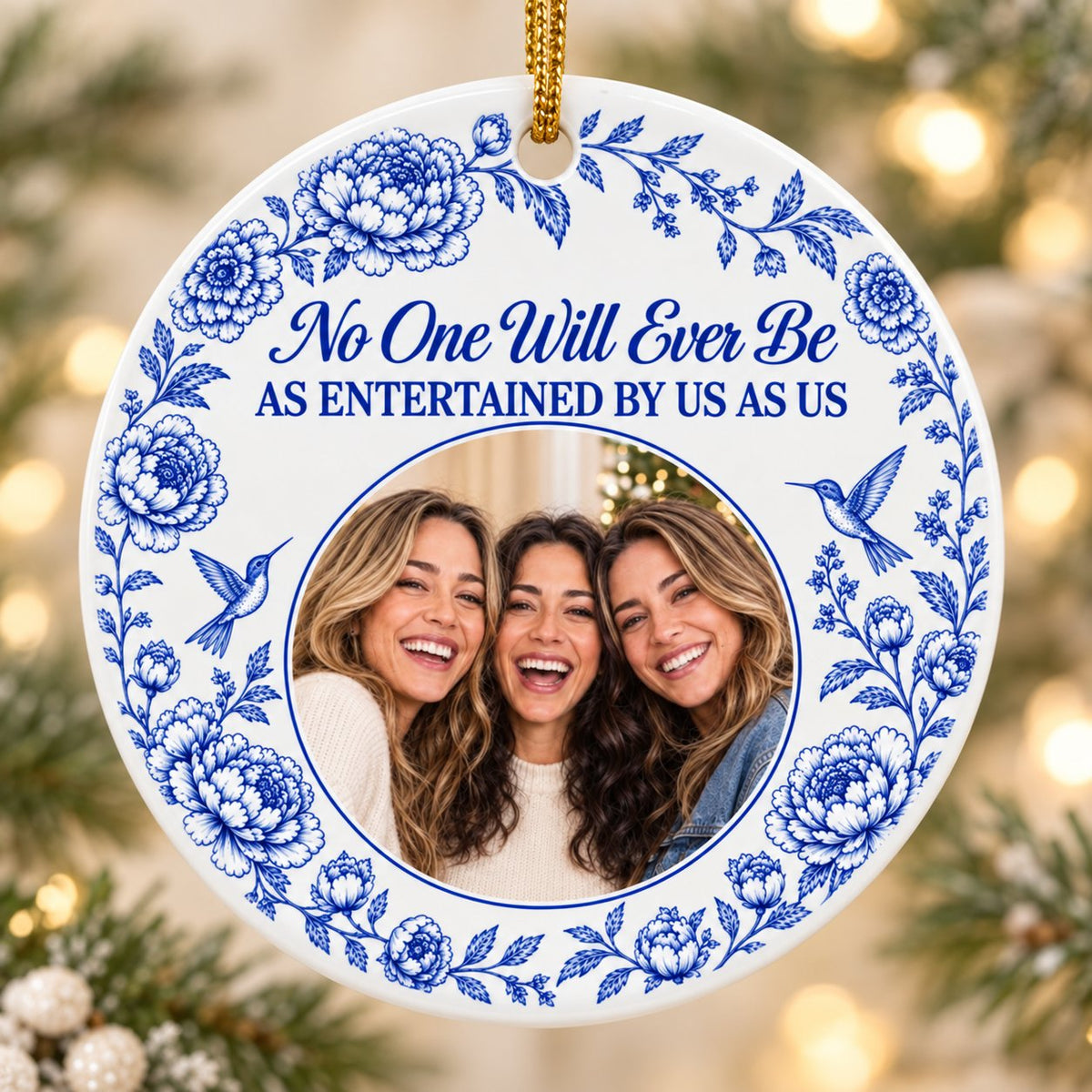 Round white ceramic ornament with blue floral border, two hummingbirds and a central circular photo frame with friends.