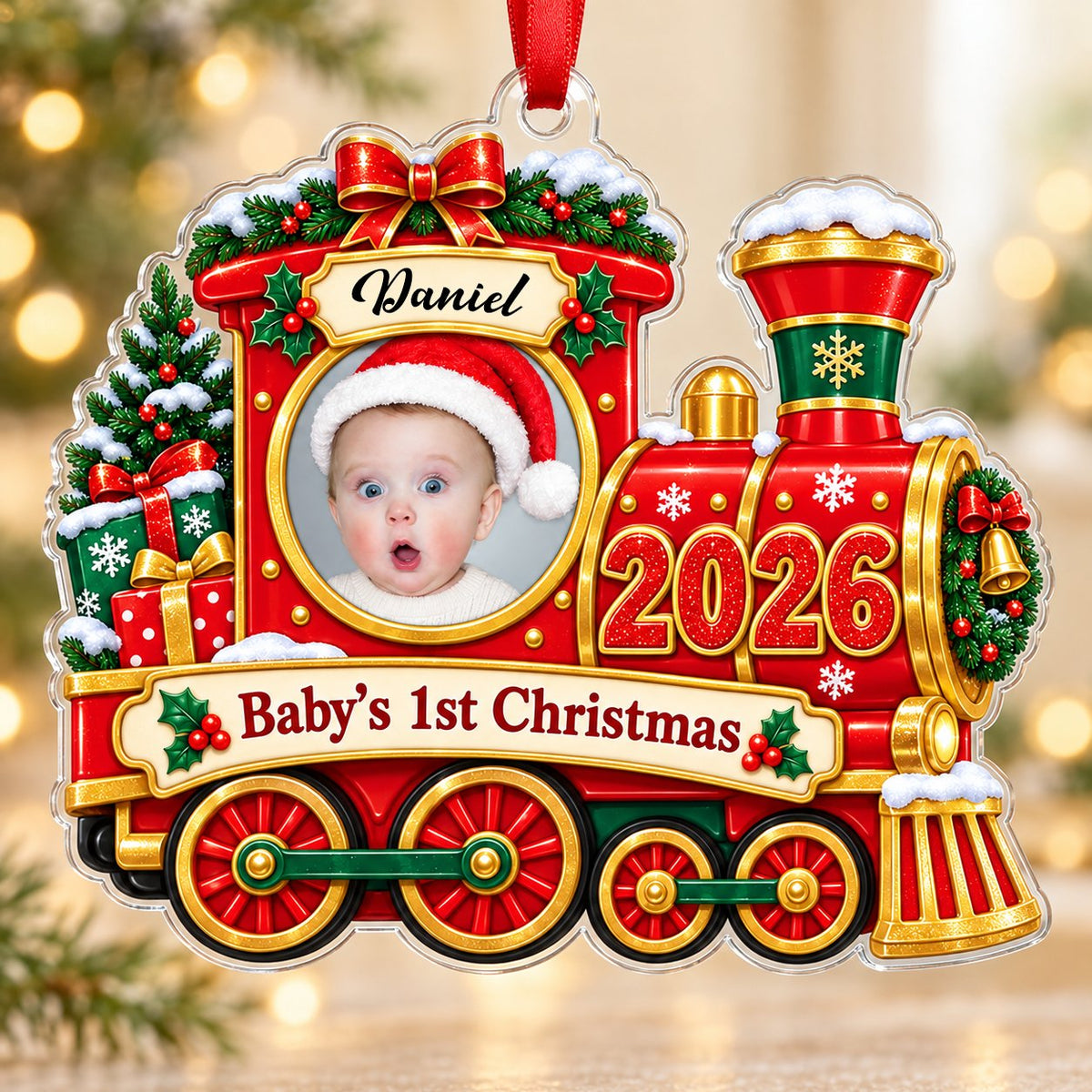 Red and gold train ornament with circular baby photo, bow, holly, wreath and 'Baby's 1st Christmas' on a scroll banner.