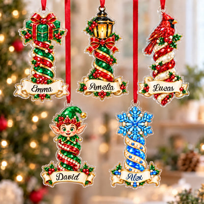 Acrylic ornament with green gift box and smiling elf, jeweled spiral columns, holly, and a name banner.