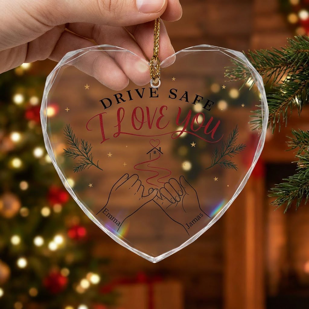 Heart glass ornament with pinky promise hands, red thread to a small house with heart, pine sprigs and gold stars.