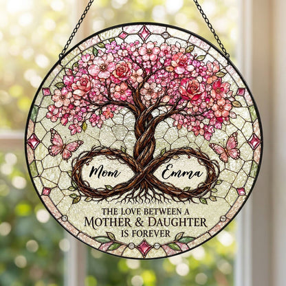 Round suncatcher with tree of life, pink blossoms, and 'THE LOVE BETWEEN A MOTHER & DAUGHTER IS FOREVER'