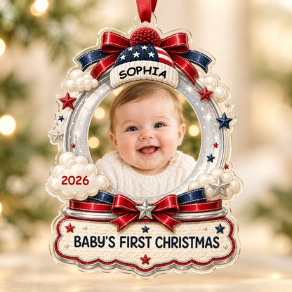 Custom-cut acrylic ornament with baby's photo, patriotic beanie, red bows, stars, and 'Baby's First Christmas' banner.