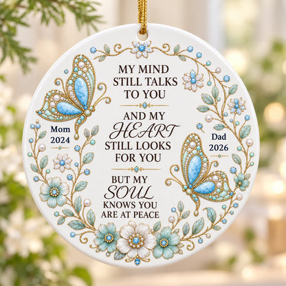 White round ornament with jeweled butterflies, floral wreath, and memorial quote with personalized name and year.