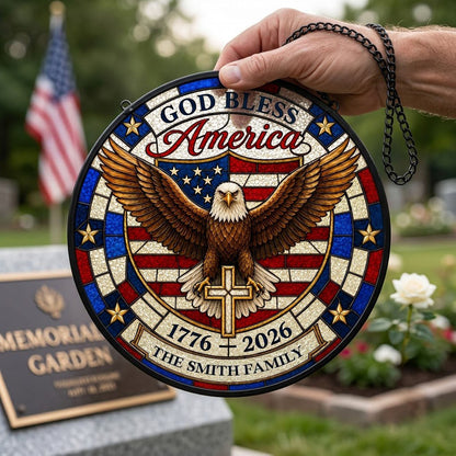 Round stained glass-look suncatcher with a bald eagle over a gold cross and an American flag shield with family name.