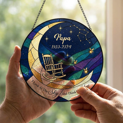 Round stained-glass suncatcher with a crescent moon, rocking chair, fireflies and a memorial banner.
