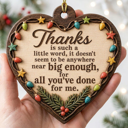 Heart-shaped wood ornament with a lights-and-stars border, pine sprigs with red berries, and a gratitude quote.