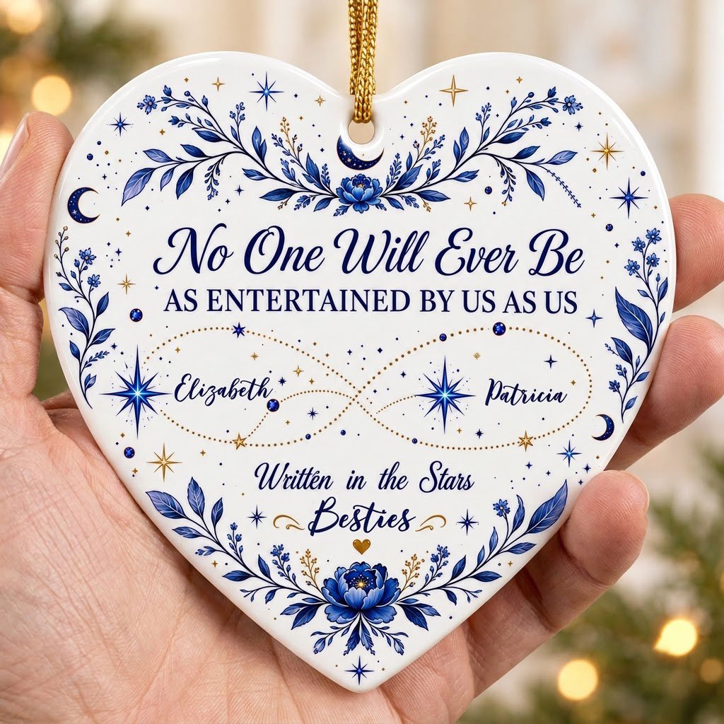 White heart ceramic ornament with blue florals, moons, stars, and “Written in the Stars Besties” with two names.