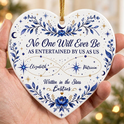 White heart ceramic ornament with blue florals, moons, stars, and “Written in the Stars Besties” with two names.