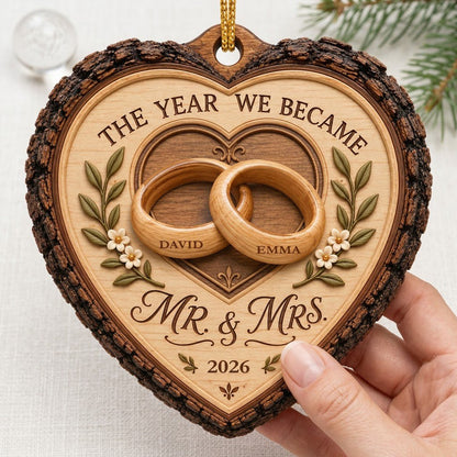 Heart-shaped wood ornament with bark edge, wedding rings, leafy vines, and 'THE YEAR WE BECAME MR. & MRS.' text.