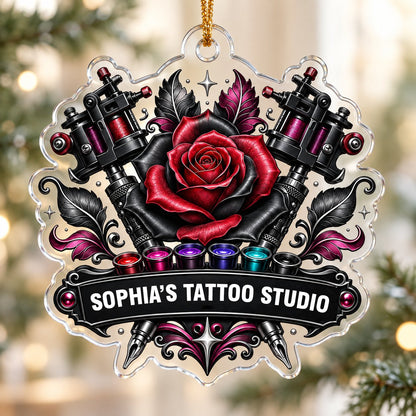Clear acrylic ornament with red and black rose, crossed tattoo machines, caps, and SOPHIA'S TATTOO STUDIO text.