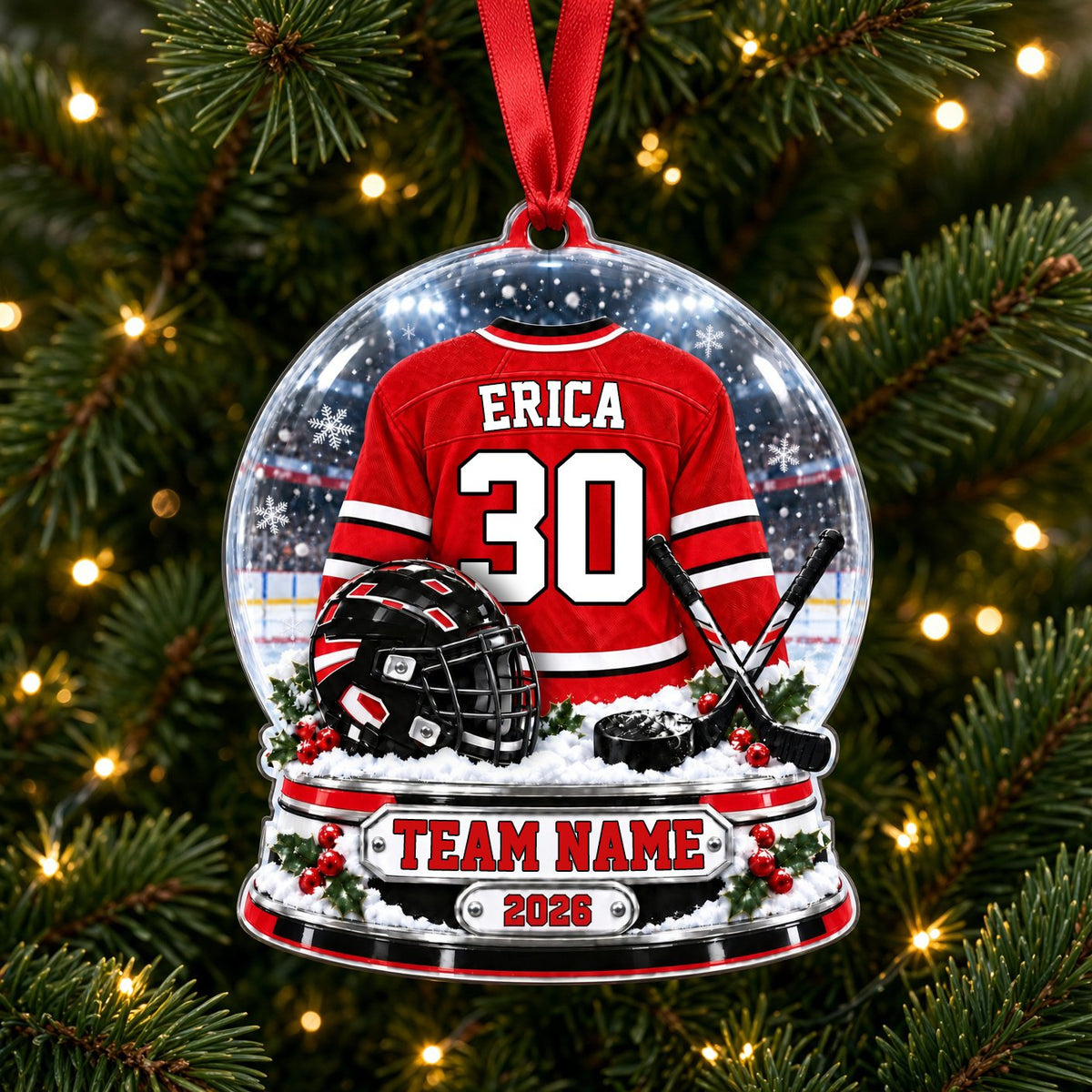 Snow globe acrylic ornament with red and white hockey jersey, black helmet and puck, and a snowy rink backdrop.
