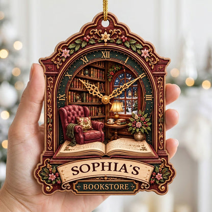 Ornate clock-shaped wood ornament with cozy bookstore scene, red armchair, bookshelves, arched window, and “BOOKSTORE” s