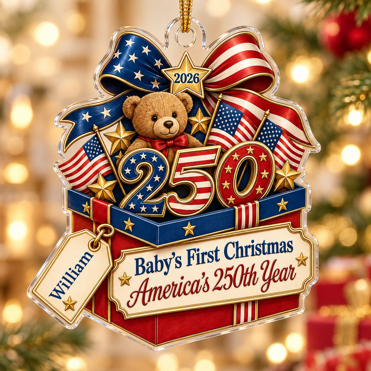 A teddy bear in a red gift box with blue trim, 250 and 2026 with American flags and a patriotic bow on an acrylic orname