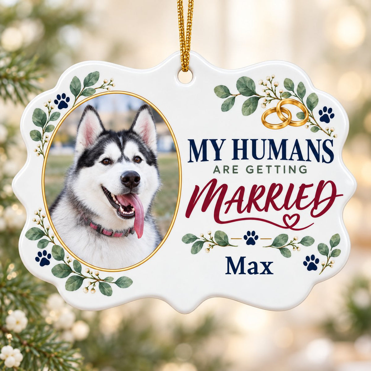 Scalloped medallion ornament with dog photo, eucalyptus, paw prints, and 'MY HUMANS ARE GETTING MARRIED' text.