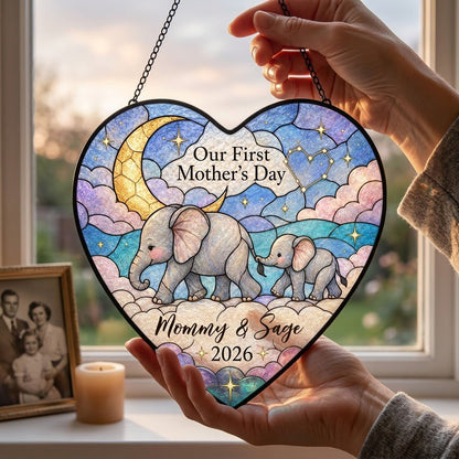 Heart stained-glass suncatcher with mom and baby elephants, crescent moon, pastel clouds, and gold stars.