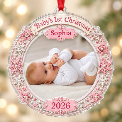 Round acrylic ornament with pink and white snowflakes framing a baby photo and the words Baby's 1st Christmas.