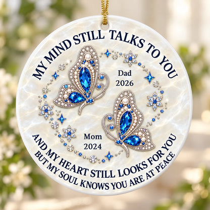 Round ceramic ornament with jeweled blue butterflies, floral rhinestones, and a cream marble background with memorial qu