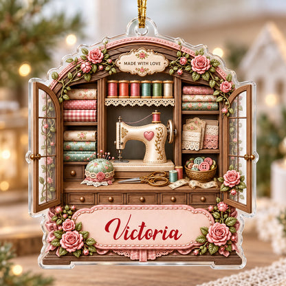 Acrylic ornament shaped like a sewing cabinet with roses, sewing machine, scissors and a pink name banner.