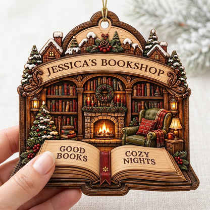 Custom-cut wood ornament with arched loop and open book base, cozy bookshop scene with tree, fireplace, armchair.