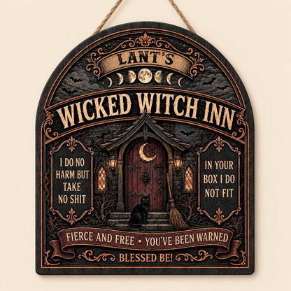 Arch wooden sign with a witch's cottage, bats, moon phases, red crescent door, broom, and a black cat on the steps.