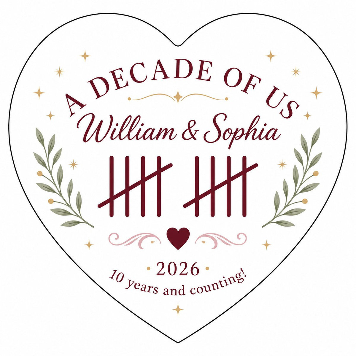 Heart ceramic ornament with 'A Decade of Us', • 2026 •, tally marks, green branches, gold stars, and couple names.