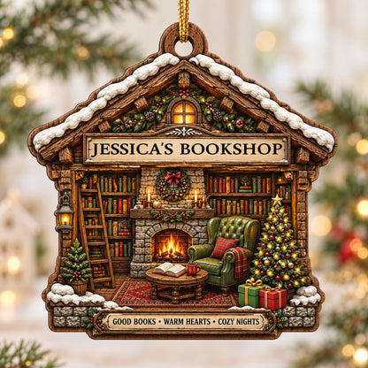 House-shaped wood ornament with cozy bookshop scene, fireplace, bookshelves, and a lit Christmas tree.