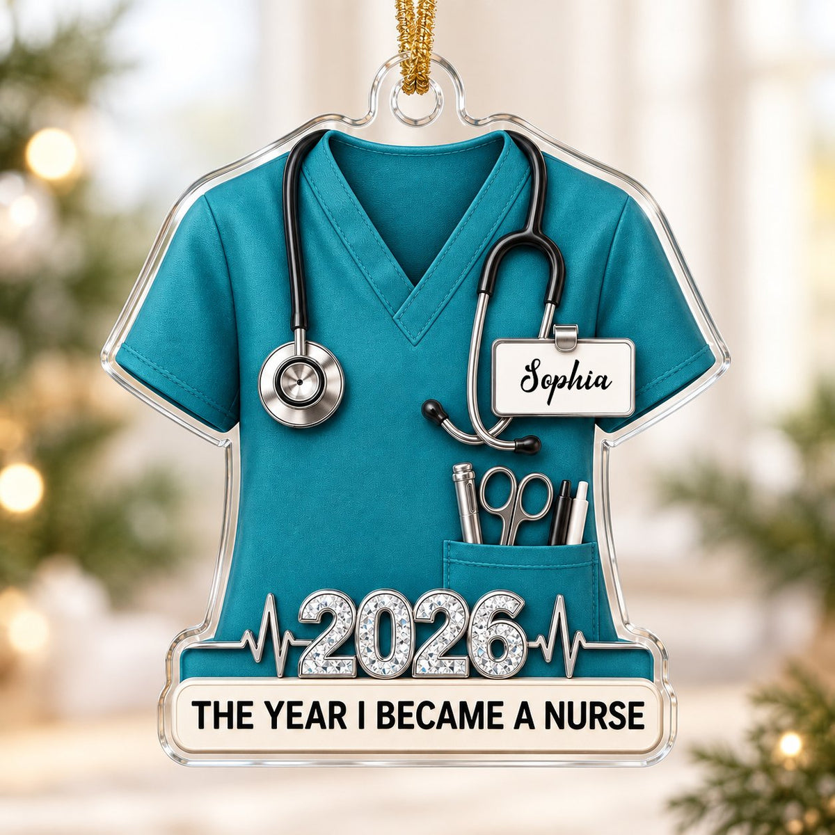 Teal scrub top acrylic ornament with stethoscope, ID badge, pocket tools, EKG line, 2026 numerals and a white name banne