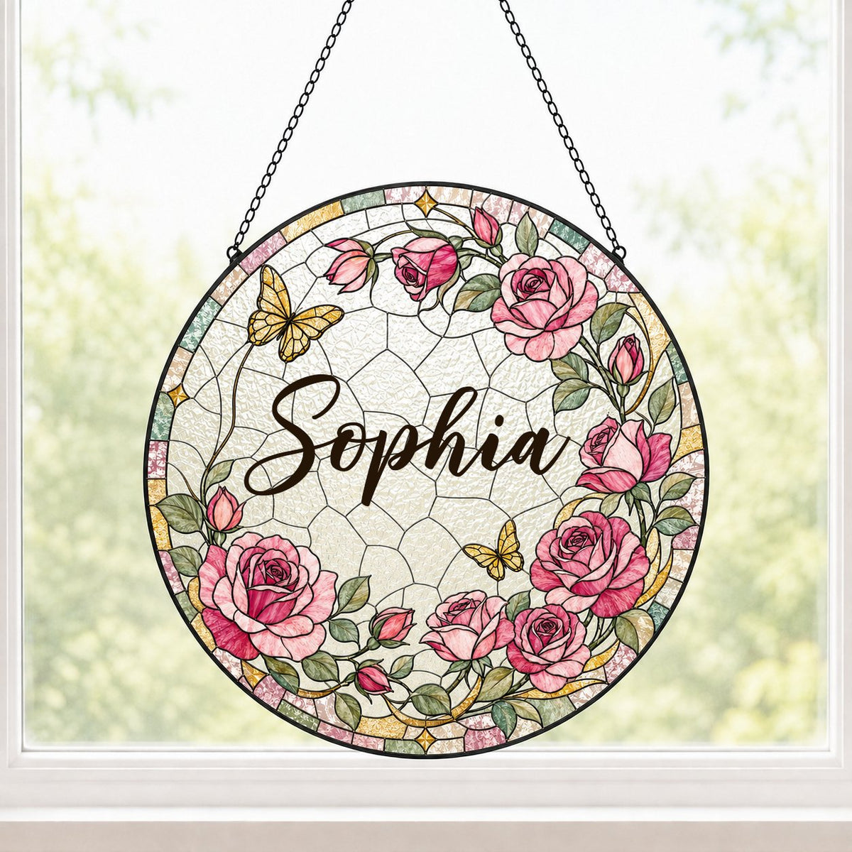 Round stained-glass style suncatcher with pink roses, two yellow butterflies, green leaves, and a decorative patterned b