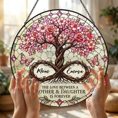 Round suncatcher with tree of life, pink blossoms, and 'THE LOVE BETWEEN A MOTHER & DAUGHTER IS FOREVER'
