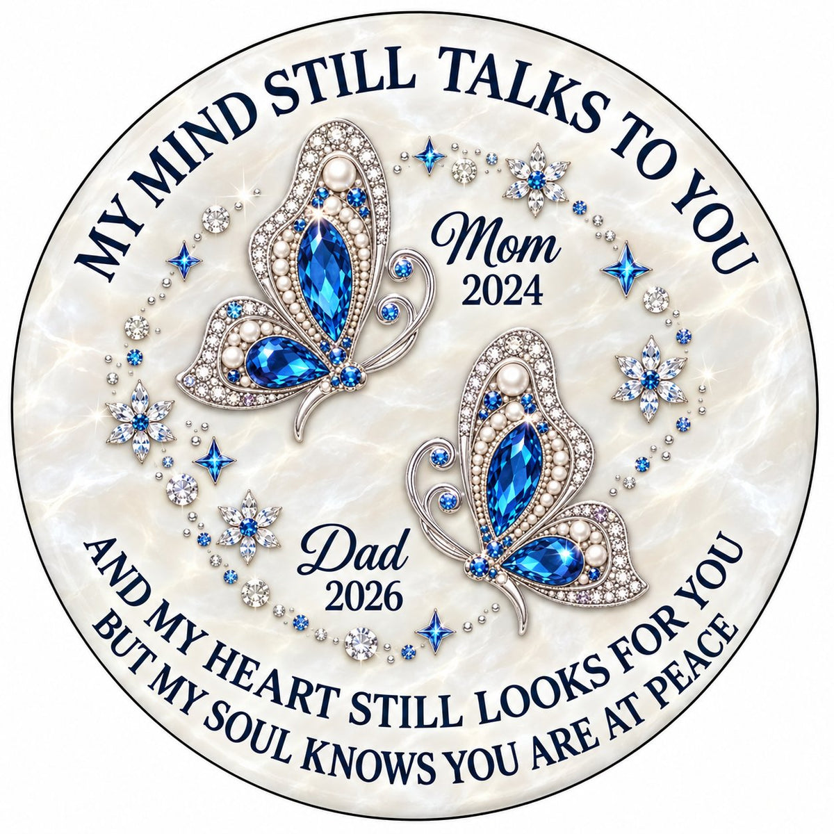 Round ceramic ornament with jeweled blue butterflies, floral rhinestones, and a cream marble background with memorial qu