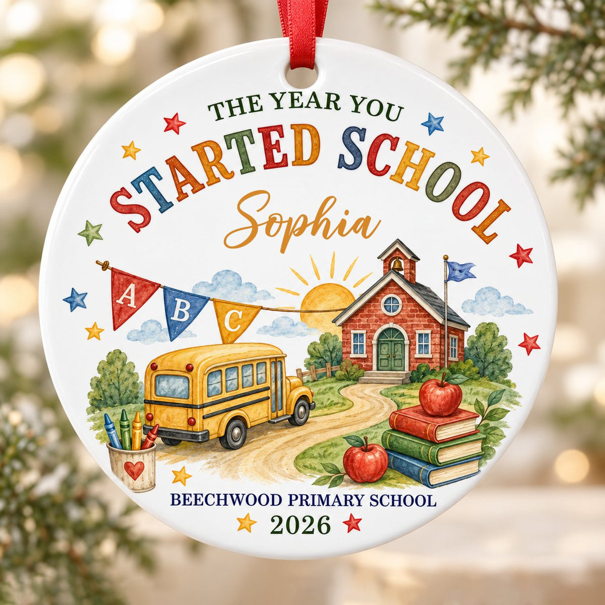 Round ceramic ornament with watercolor school bus, red brick schoolhouse, ABC bunting, books, apples, and colorful stars