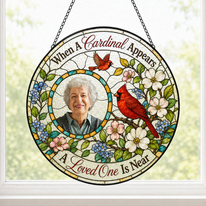 Round faux stained-glass suncatcher with two red cardinals, dogwood flowers, and a left-side circular photo frame.