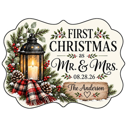 Medallion ceramic ornament with black lantern, pine, red berries, plaid scarf, and 'FIRST CHRISTMAS as MR. & MRS.' text.