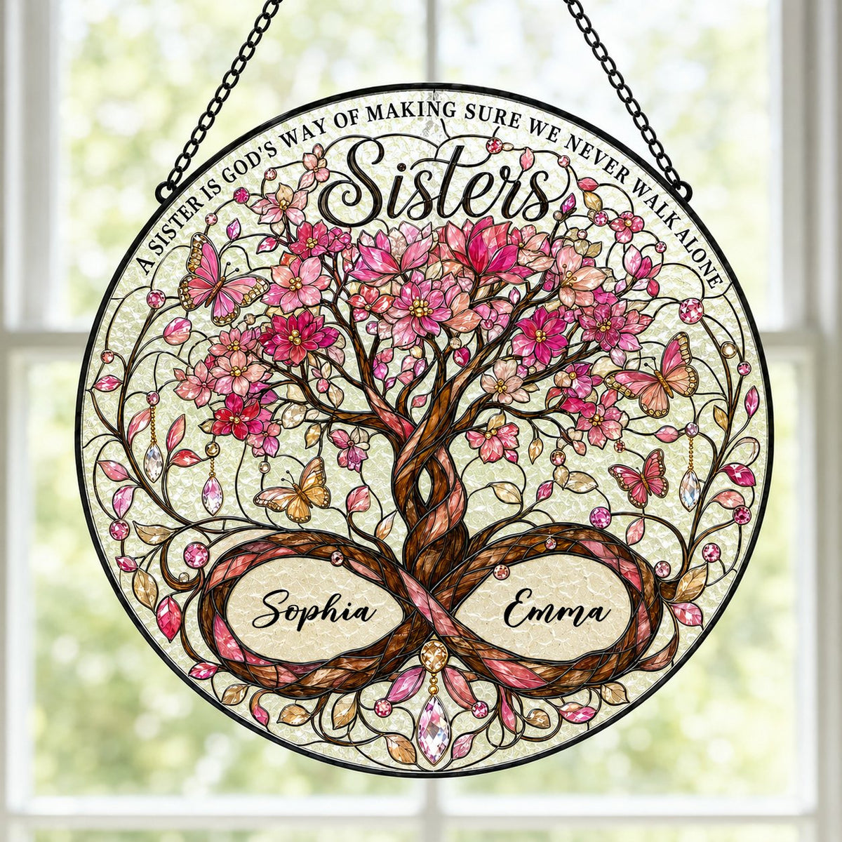 Round stained glass suncatcher with tree of life, pink blossoms, butterflies, and Sisters text with two names.