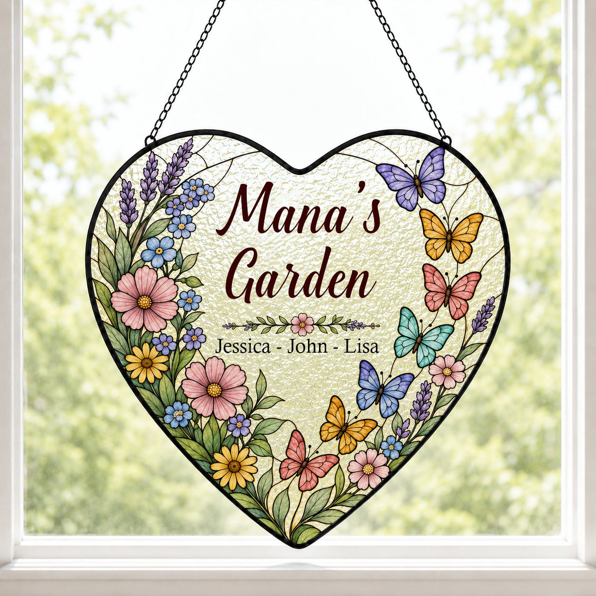 Heart stained-glass suncatcher with floral border, colorful butterflies, and 'Mana's Garden' with kids' names.