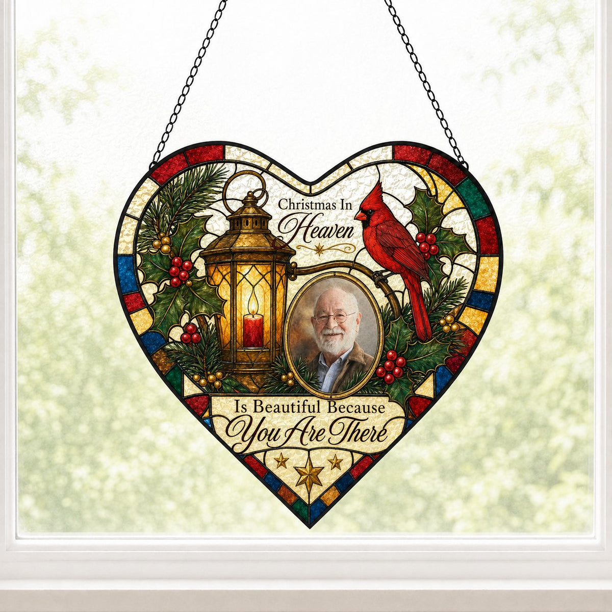 Heart stained glass suncatcher with lantern, red candle, red cardinal, holly, pine, and an oval photo frame.